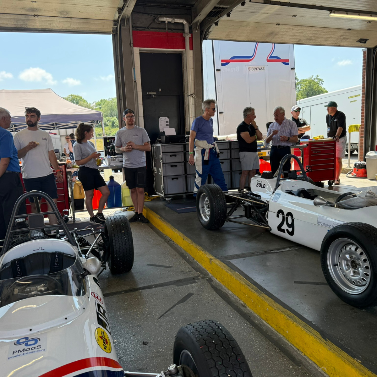 Guests and Formula Ford cars in the garage